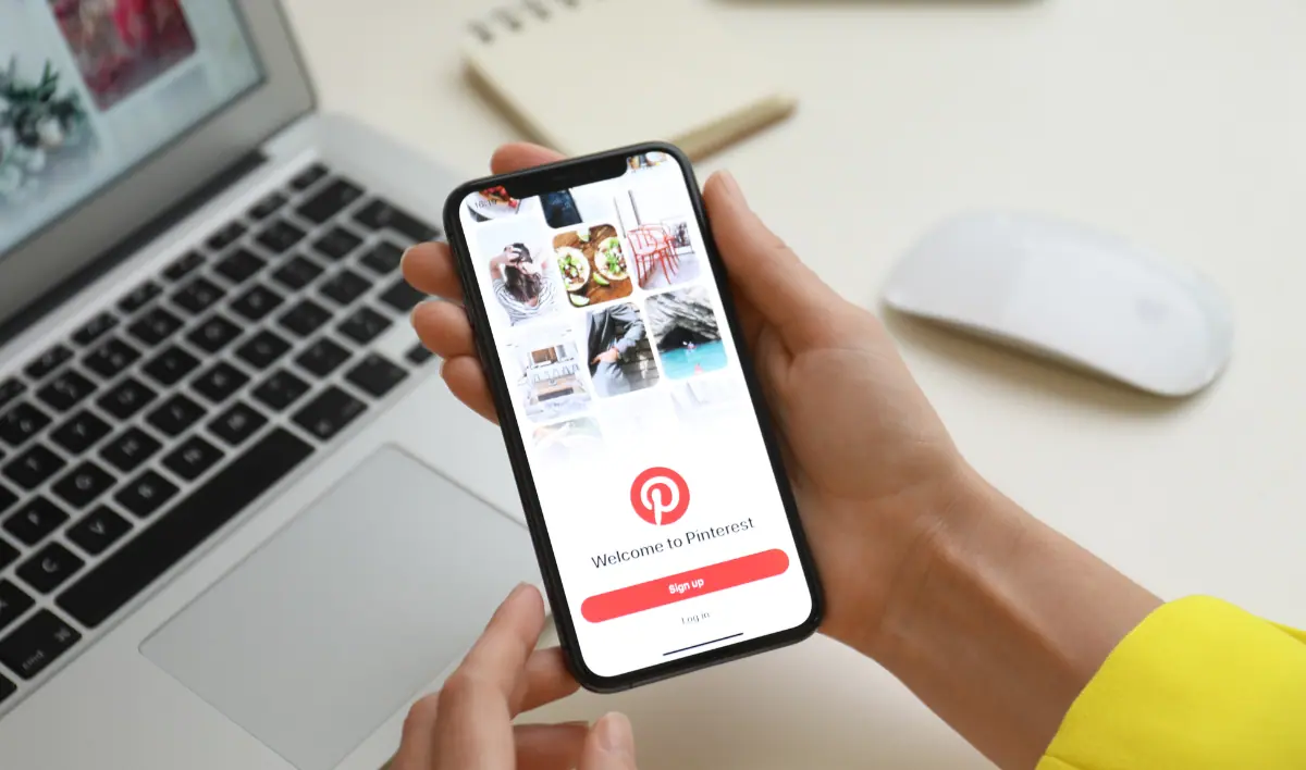 Woman hands holding a phone with pinterest login screen