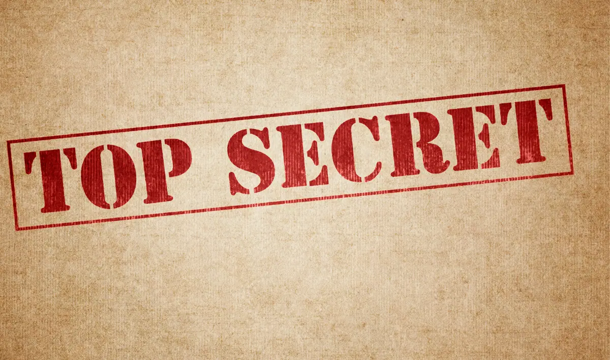 Phrase "TOP SECRET" written on a beige background.